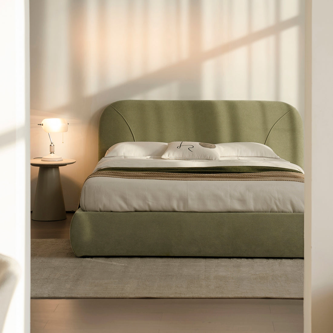 CAMA LIFESTYLE VIGO EN UNA HABITACIÓN EN TONOS CÁLIDOS, ACOMPAÑADA DE UNA MESA LATERAL CON UNA LAMPARA ENCENDIDA 